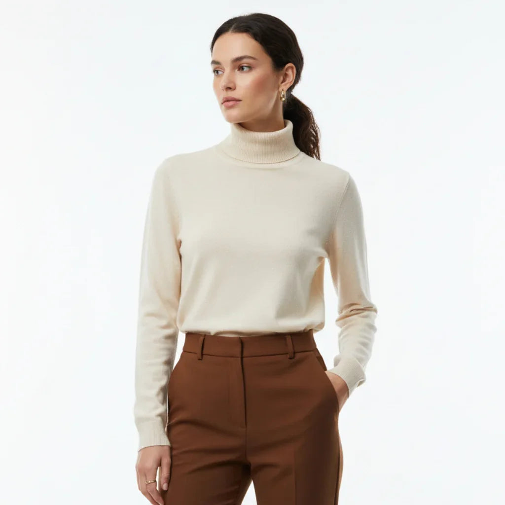Femme portant un pull à col roulé crème et un pantalon marron ajusté